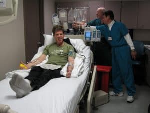 Steve in hospital bed, ready to go.